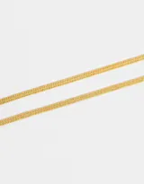 Set de dos pulseras doradas flexibles de acero quirúrgico con cierre de mosquetón y cadena de extensión.