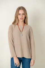 Sweater de lana color beige, de corte holgado y mangas largas.