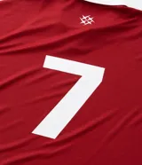 Remera de manga corta estilo polo, color rojo, con cuello y puños en contraste blanco. Presenta un corte oversized con hombros caídos y la palabra "ATHLÈTES" estampada en blanco en el frente. Incluye pequeños gráficos blancos a cada lado del pecho.