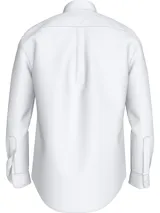 Camisa blanca de popelina de algodón con tecnología Flex que proporciona elasticidad en cuatro direcciones. Tiene cuello con botones, puños redondeados con botón y logo de Tommy Hilfiger bordado en el pecho.