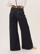 Pantalón ancho de algodón color verde militar, con corte holgado, pinzas debajo de la rodilla y pespuntes a contratono. Presenta un bordado de monograma en el bolsillo delantero.