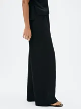 Pantalón negro de corte recto y cintura media.