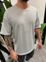 Remera gris claro de punto con cuello redondo y corte oversize.