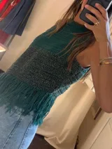Top tejido a crochet con diseño de bloques de color verde y gris, y flecos en el ruedo.