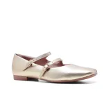 Zapato de cuero color cobre con dos tiras sobre el empeine y hebillas doradas. Taco bajo y punta redondeada.