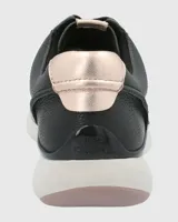 Zapatillas urbanas Hush Puppies modelo Goss, color negro con detalles metalizados en el talón y cordones. Confeccionadas en cuero, con suela Zero G y plantilla Bloom de algas recicladas.