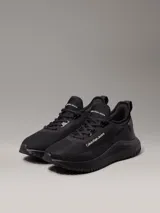 Zapatillas urbanas Calvin Klein Jeans modelo Eva Runner, color negro, confeccionadas en malla reciclada y material sintético, con logo en el lateral.