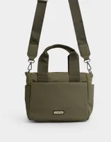 Cartera tipo tote color blanco hueso, con doble asa corta negra y correa larga negra regulable y desmontable. Tiene cierre superior, bolsillos laterales y tag de goma con el logo de la marca.