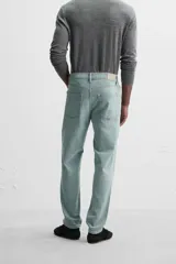 Pantalón de jean azul oscuro, corte slim fit, tiro medio, cinco bolsillos, tejido elástico y efecto lavado.
