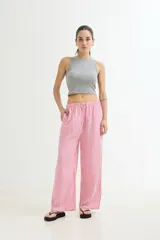 Pantalón palazzo de algodón a rayas verticales rosas y blancas, con cintura elástica ajustable con cordón.