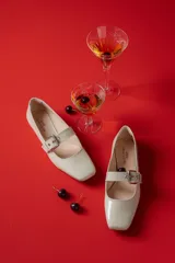 Chatitas tipo Mary Jane de charol negro con punta redondeada y tira sobre el empeine con hebilla metálica plateada.