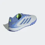Championes de fútbol Adidas Copa Pure 3 League para pasto sintético, color plateado metálico con detalles en azul lavanda y cordones en el mismo tono. Presentan las tres franjas de Adidas en azul con un borde de costura zigzag en color verde lima.
