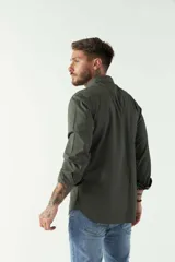 Camisa de hombre color marrón con efecto stone wash, fit regular, cuello americano, cierre con botones, dos bolsillos frontales con botón y mangas largas con puños abotonados.