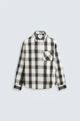 Camisa regular fit de manga larga con puños abotonados, confeccionada en tejido de algodón a cuadros en tonos blanco, negro y beige. Cuenta con cuello solapa, bolsillo de plastrón en el pecho y cierre frontal con botones.