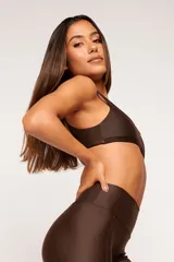 Top deportivo reversible color bordó, con diseño slim, tirantes finos y espalda descubierta. Un lado tiene acabado brillante y el otro textura 3D tipo colmena.