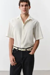 Pantalón de jean negro de corte recto y holgado, con tiro alto y cinco bolsillos.