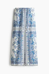 Pantalón palazzo de tiro alto con cintura elástica y cordón ajustable. Estampado paisley en tonos azules y blancos.