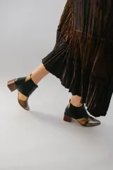 Botinetas de cuero con diseño patchwork en negro, dorado, plateado y marrón. Tienen elásticos laterales, taco cuadrado de madera y puntera fina.