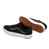 Championes negros con detalles en gris y suela blanca, modelo clásico de Vans.