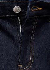 Pantalón de jean de tiro medio, color azul oscuro, con diseño acampanado y cinco bolsillos.