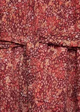 Vestido corto de manga larga con puños elásticos, estampado floral y lazo ajustable en la cintura.