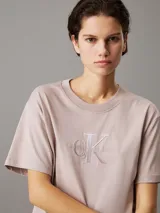 Remera color lila claro de corte holgado, cuello redondo y mangas cortas. Presenta un logo bordado en relieve en el pecho con el monograma CK y la leyenda 'Calvin Klein Jeans'.
