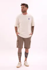 Remera color crudo de corte holgado con estampado pequeño en el frente.