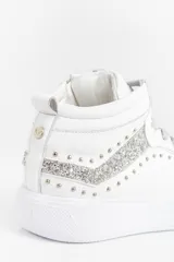 Zapatilla tipo botita de cuero negro con recortes de glitter negro y reptil, detalle de remaches metálicos y acceso lateral con cierre.