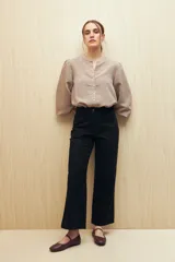 Pantalón recto negro de algodón con tiro medio y bolsillos delanteros.