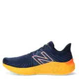 Championes de running New Balance Fresh Foam X Vongo V5, color azul marino con detalles en naranja.