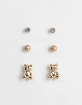 Set de tres pares de aros dorados con distintos diseños: un par con strass, un par con forma de esfera texturizada y un par con forma de oso.