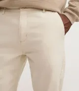 Pantalón de sarga color beige, corte recto, con cintura fija con trabillas, cierre por cremallera y botón, y bolsillos laterales y traseros.