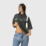 Remera de algodón 100% con efecto acid wash gris oscuro y estampado en la espalda con el logo "Venefo" en celeste, junto con texto que dice "Industries Company | 004®1994 Worldtribe Co".