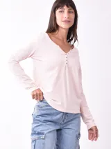 Remera color rosa pálido de manga larga con escote en V y botones.