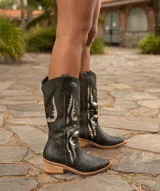 Bota texana de caña alta color beige, confeccionada en cuero vacuno con cierre interno YKK. Presenta bordados decorativos en la caña y taco de madera con folia de cuero.