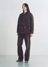 Pantalón de jean negro de corte recto, tiro alto y cinco bolsillos.