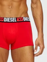 Bóxer negro de algodón con cintura elástica roja y logo "DIESEL" en blanco.