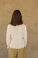 Camisa blanca de bambula de algodón con botones de nácar y corte holgado.