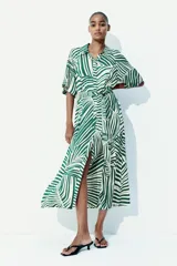 Vestido midi camisero con estampado de rayas verdes y blancas, cuello camisero, botonadura frontal, mangas cortas raglán, elástico en la cintura y cinturón extraíble para atar.