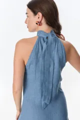 Vestido largo azul de lino, con cuello halter y volados en el ruedo.