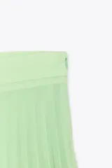 Falda midi plisada color verde menta, de tiro alto, con forro interior y cierre lateral con cremallera oculta.