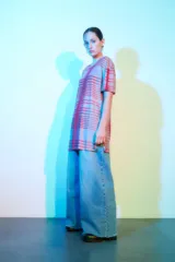 Remera oversize de mesh con diseño a rayas en tonos rosa y rojo, de manga corta y con transparencia.