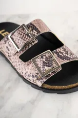 Sandalias con estampado de serpiente, con hebillas plateadas y suela de corcho.