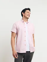 Camisa azul de manga corta, con cuello abotonado y bolsillo en el pecho.