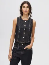 Chaleco corto de denim negro con apliques metálicos y flecos en el ruedo.