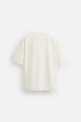 Camiseta negra de corte cuadrado, con cuello redondo, mangas cortas y efecto lavado.