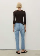 Jeans mom fit de tiro alto, color celeste claro, con cinco bolsillos y cierre frontal con cremallera y botón.