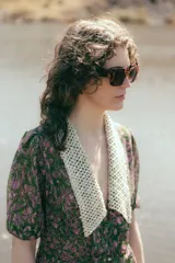 Vestido midi de gasa crepe con estampado floral en tonos verdes y violetas, cuello camisero con detalle de tejido calado y mangas cortas abullonadas.