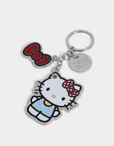 Llavero metálico plateado con dijes esmaltados de Hello Kitty, un moño rojo y un dije circular con el logo de Hello Kitty.