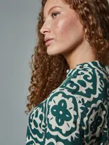 Blusa con cuello mao y estampado floral en tonos verde y blanco.